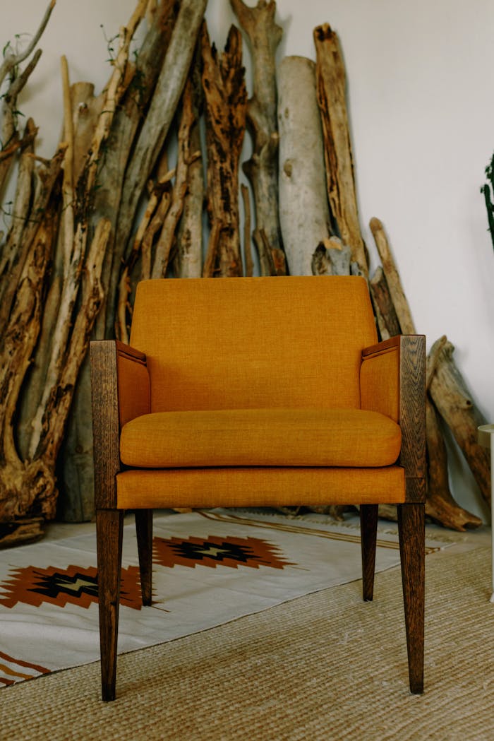 Mid-century armchair with vibrant fabric and minimalist wood design in a cozy setting.